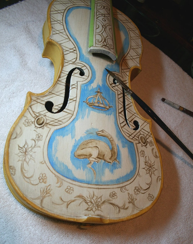 Progress photo of painted violin by artist Marsha Bowers