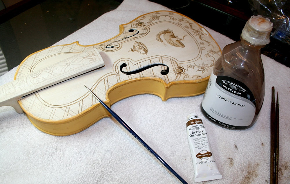 Progress photo of painted violin by artist Marsha Bowers